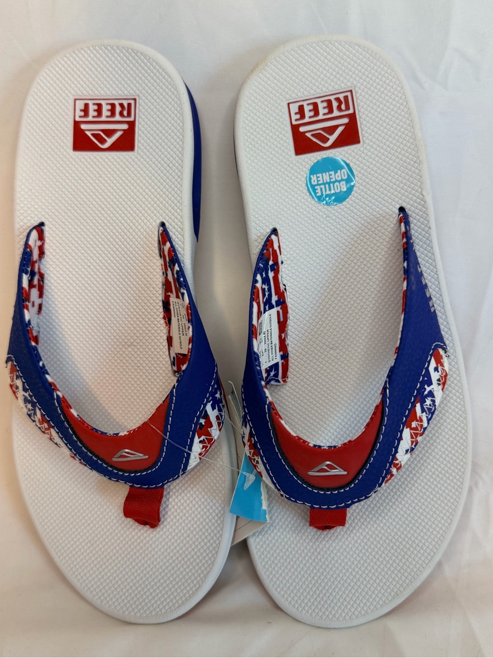 Reef Fanning Patriotic men's flip flops featuring a built-in bottle opener